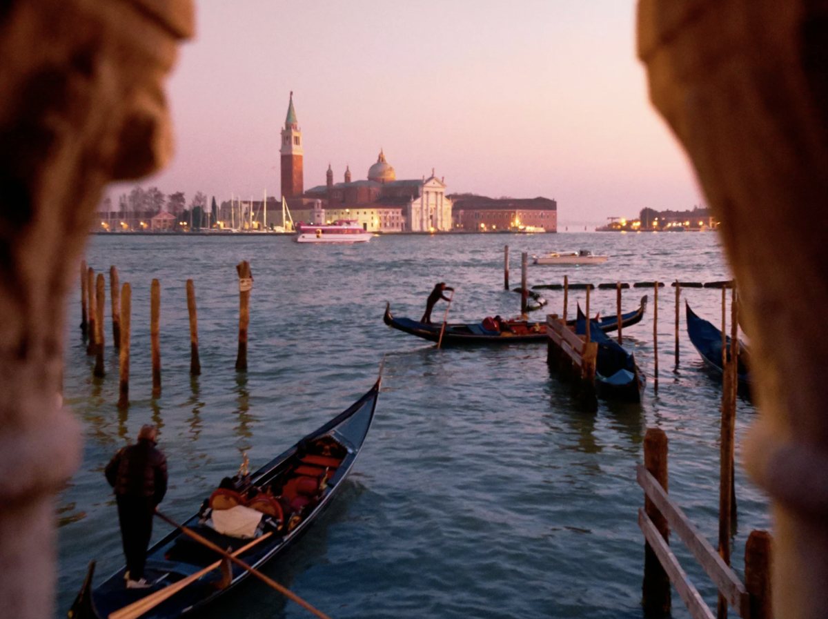 Gondolas moored on the Venetian lagoon at dusk, with San Giorgio Maggiore beyond